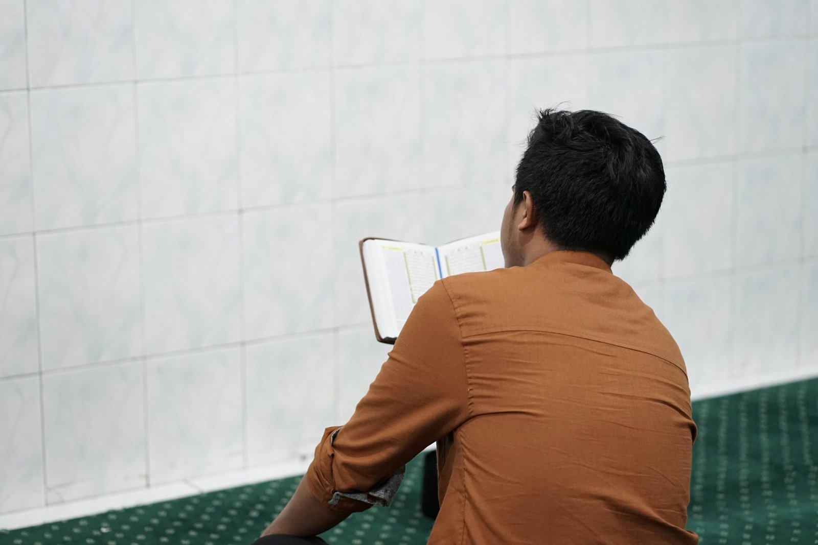 a man sitting in a chair reading a book